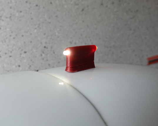 close-up of PosLi-P on the velomobile scoop – does not sit perfect because it is only sticked temporarily (and the wires are thicker than the double sided sticky tape)