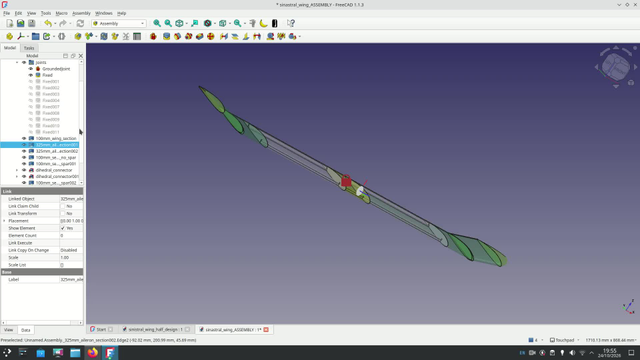 Screencapture of FreeCAD rotating a wing assembly, different sections of the wing are visible and you can see cuts for spars and a vee cut for aileron sections. The wing tips are set at a 15 degree dihedral. 